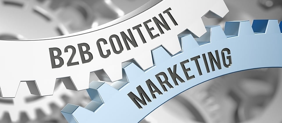 Kołowroty maszyny z napisem b2b content i marketing. Jest to metafora zależności powodzenia b2b z działaniami content marketing.