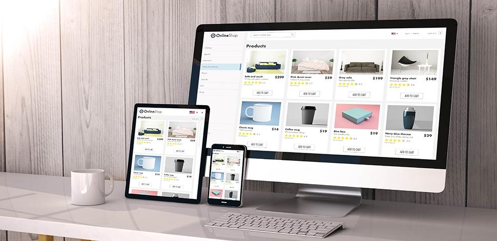 mac, tablet and a phone on the desk opened on the same online store website
